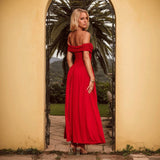Woman in a red off-the-shoulder maxi dress from behind standing in a yellow archway