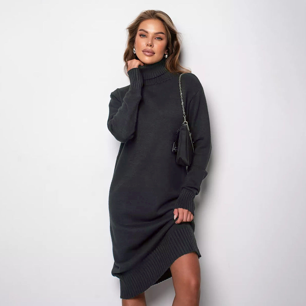 woman wearing a charcoal gray turtleneck knit midi dress with a black purse