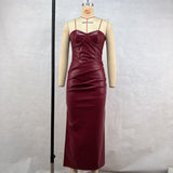 A mannequin displays a burgundy faux leather strapless maxi dress with ruching detail and a thigh-high slit.