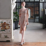 Woman in a rose gold sequined dress with an asymmetrical hemline and flutter sleeves