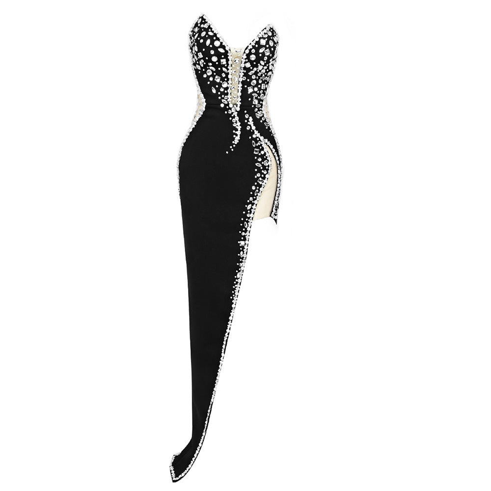 A black, strapless, high-slit gown with crystal embellishments, displayed on a white background