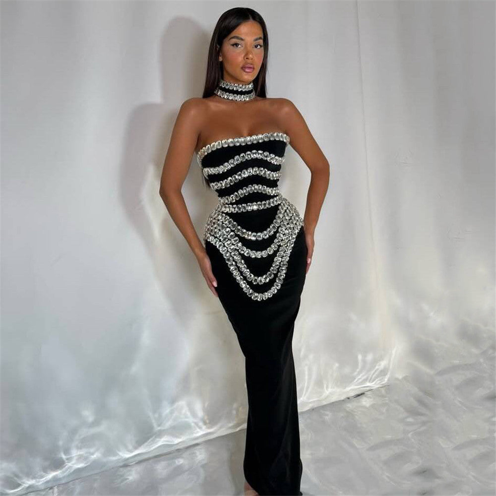 woman wearing a black strapless mermaid gown with silver beaded embellishments