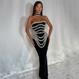 woman wearing a black strapless mermaid gown with silver beaded embellishments