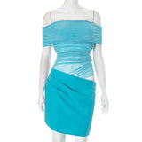 A mannequin wearing a turquoise off-the-shoulder ruched dress with sheer panels and an asymmetrical hem.
