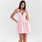 woman in pink and white gingham mini dress