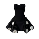 black strapless dress with white floral embellishments