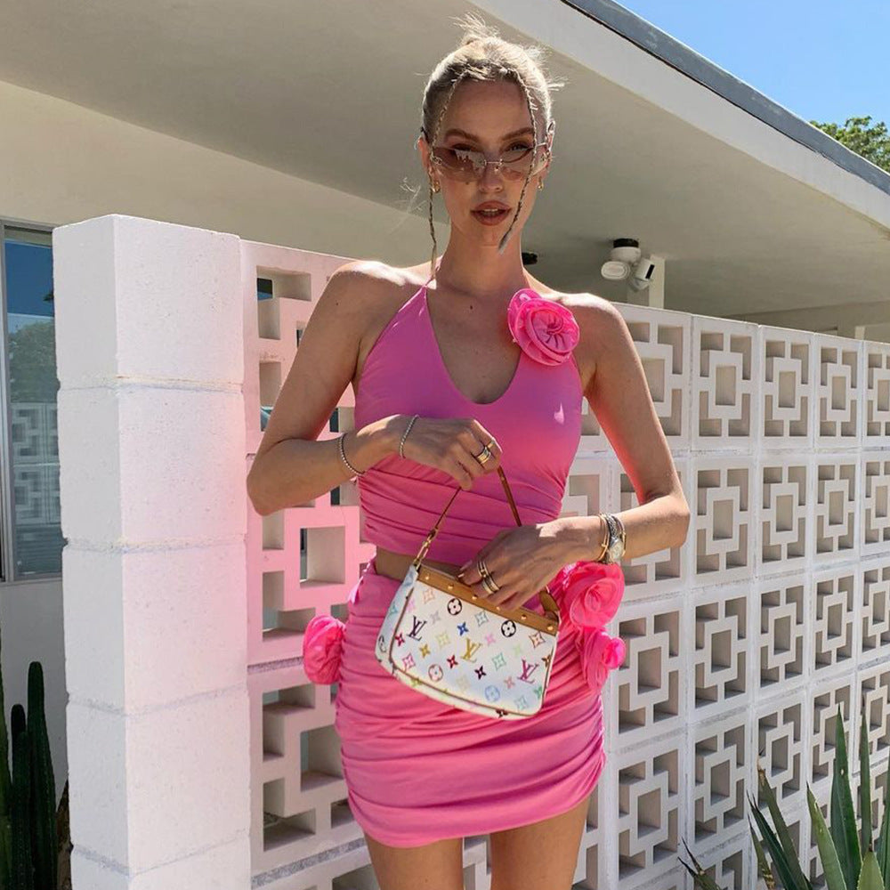 woman in pink dress with flowers and a small designer bag