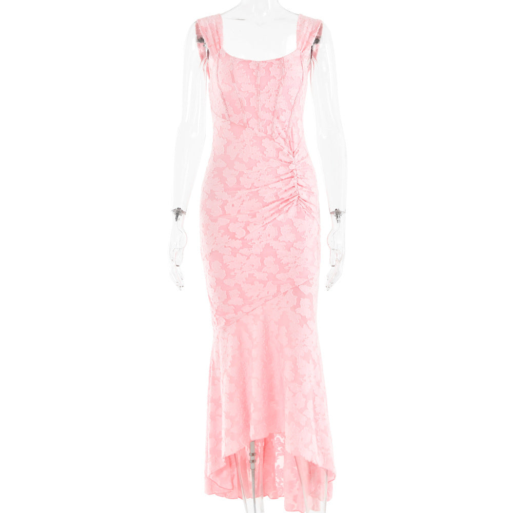 A pink textured lace dress with ruching and a high-low hemline displayed on a mannequin.