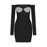 A black off-the-shoulder mini dress with long sleeves and silver embellishments on the bust, displayed flat.