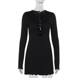 black long-sleeved mini dress with gold ring detail