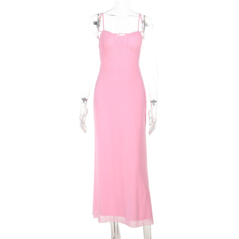 A pink slip dress displayed on a mannequin against a white background.