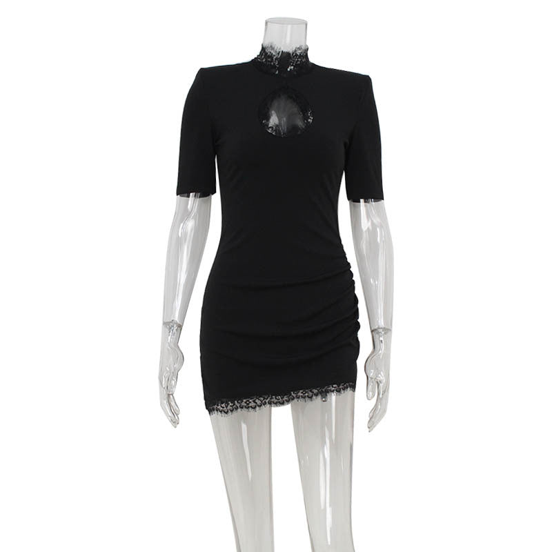 A black mini dress with lace trim, a cutout, and ruching is displayed on a mannequin.