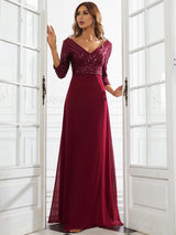 woman in a burgundy floor-length gown