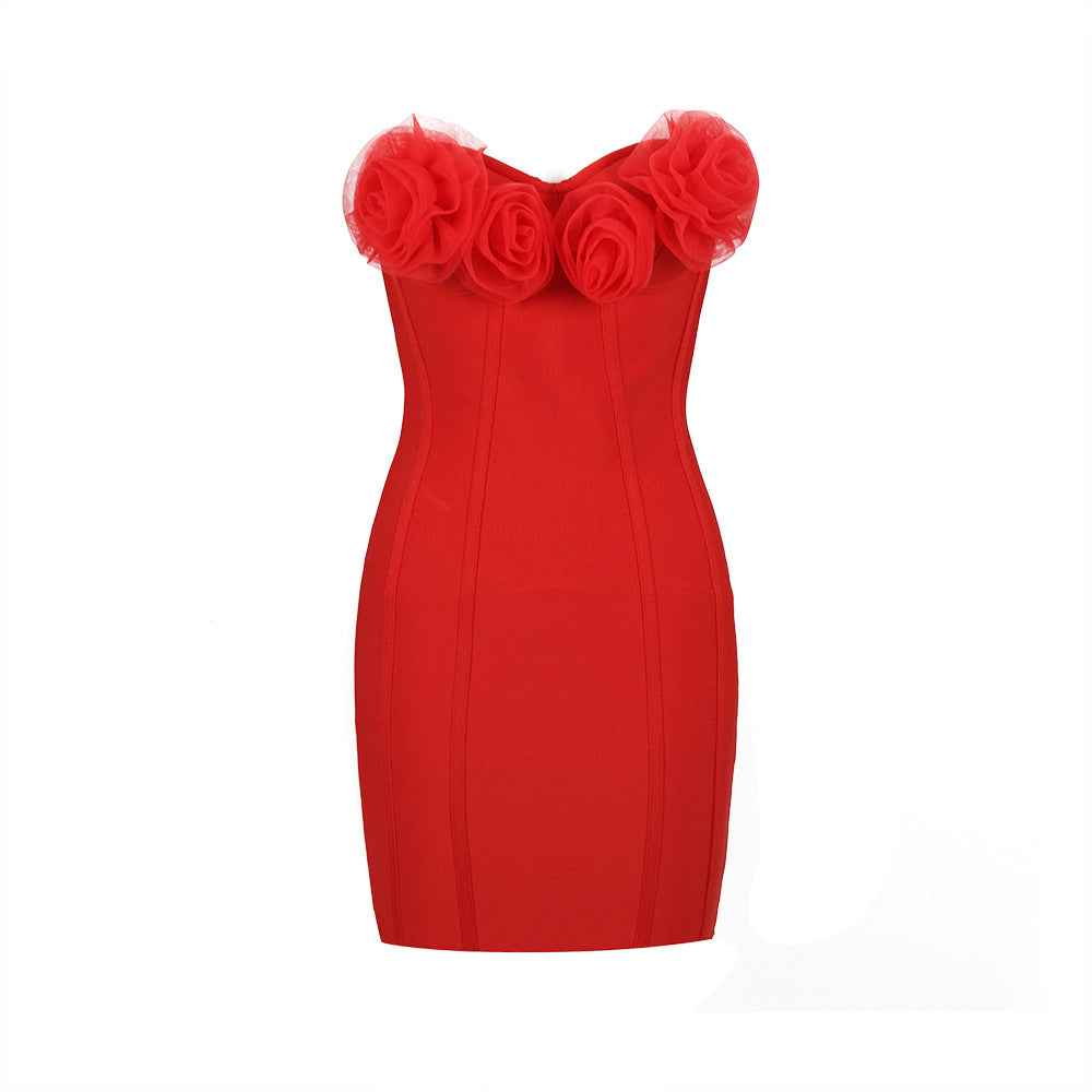 A red strapless bodycon dress with rose embellishments on the bust.