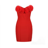 A red strapless bodycon dress with rose embellishments on the bust.
