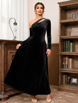 woman wearing a black velvet one-shoulder dress with a cut-out detail and long sleeves