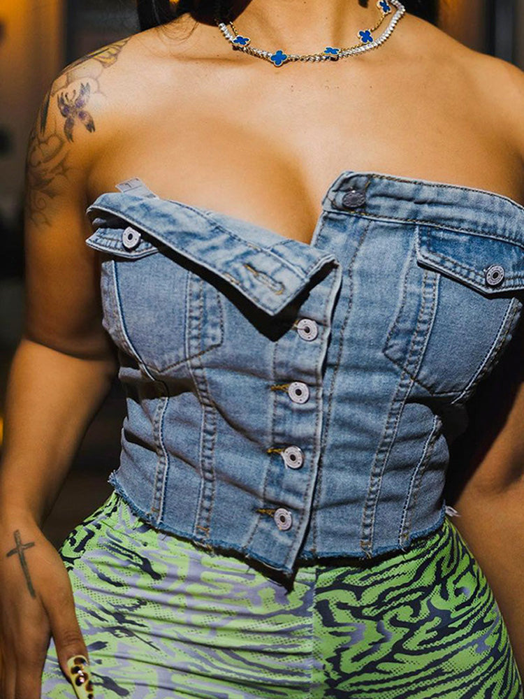 A woman wearing a blue denim strapless corset top with green and purple patterned pants