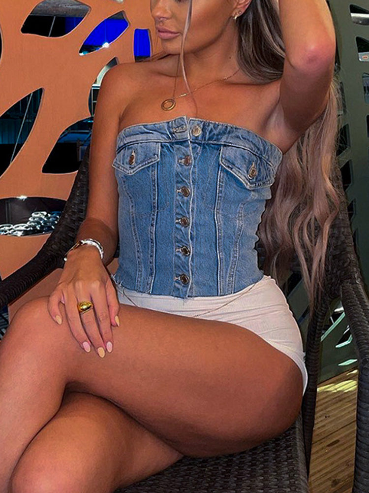 A woman wearing a blue denim strapless corset top with white shorts