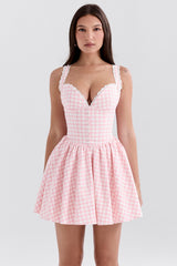 front view of woman in pink gingham dress