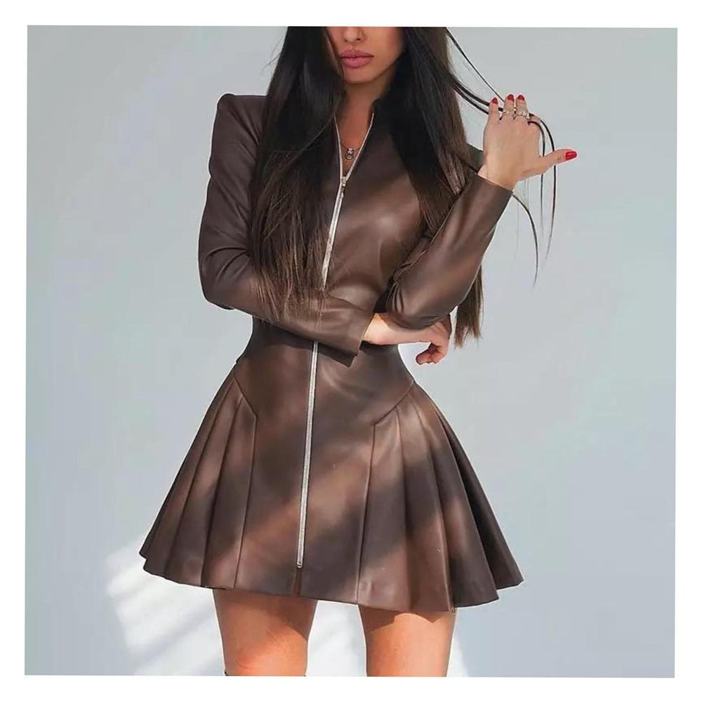 Woman wearing a brown leather-like dress with a pleated skirt and long sleeves, with a zipper closure