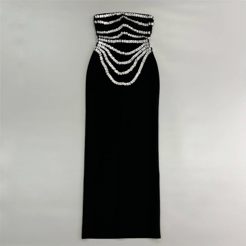 black strapless mermaid gown with silver beaded embellishments laid flat