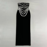 black strapless mermaid gown with silver beaded embellishments laid flat