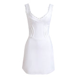 A white mini dress with lace trim and corset detailing displayed on a white background.