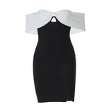 A black and white off-the-shoulder dress with a bow detail and a cut-out, shown flat against a white background.