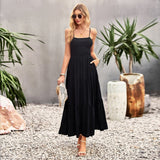 Woman wearing a black tiered maxi dress with spaghetti straps and smocked bodice
