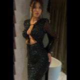Woman in a black sparkly dress with a plunging neckline and cut-out detail, shown from the side.