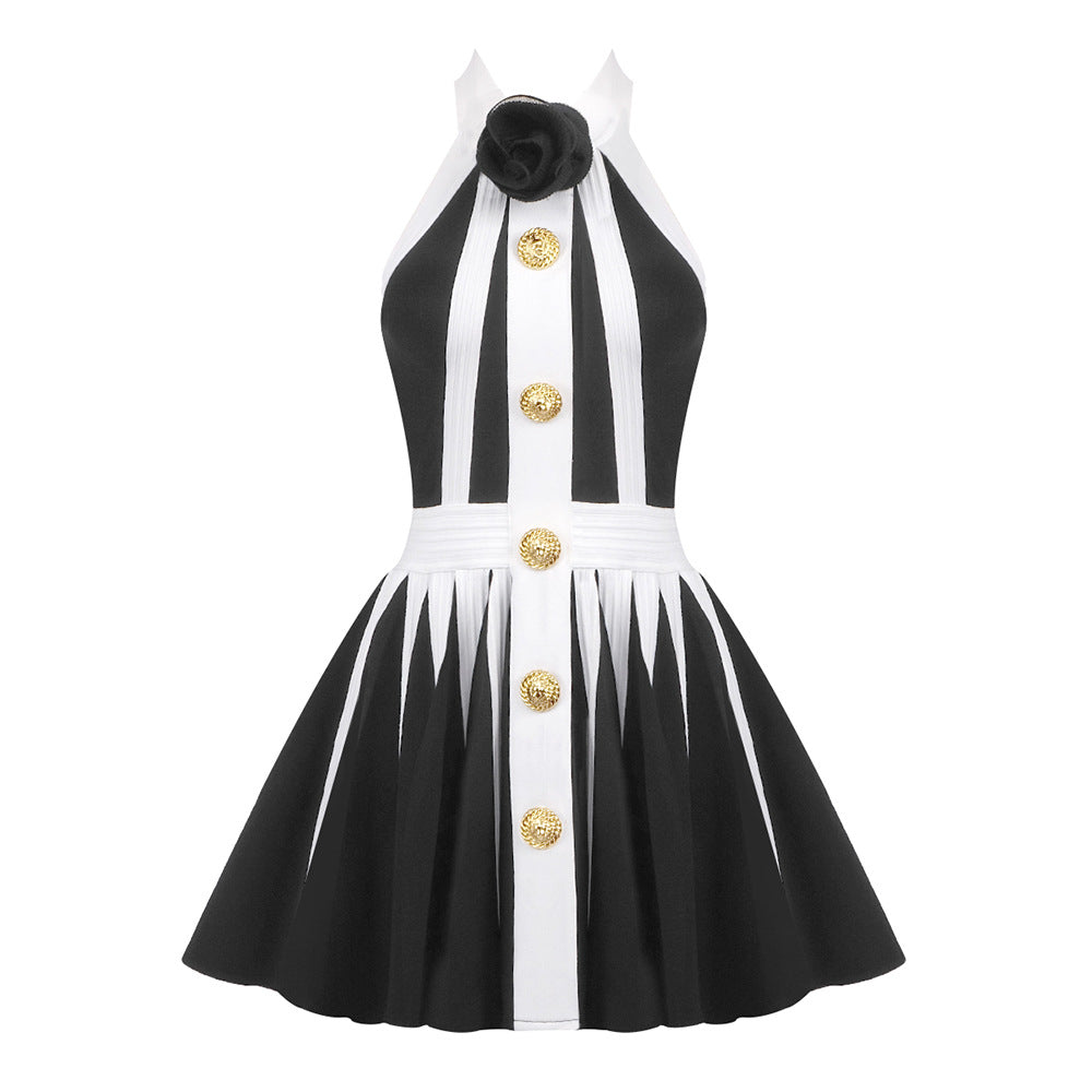 black and white halter dress with a pleated skirt and gold buttons