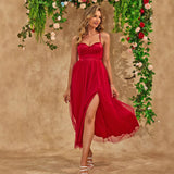 A woman in a red dress with a high slit walking