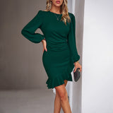 woman wearing a green long-sleeved mini dress with ruffled hem and ruched waist
