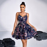 Woman wearing a navy blue floral sequined mini dress with spaghetti straps and a v-neck