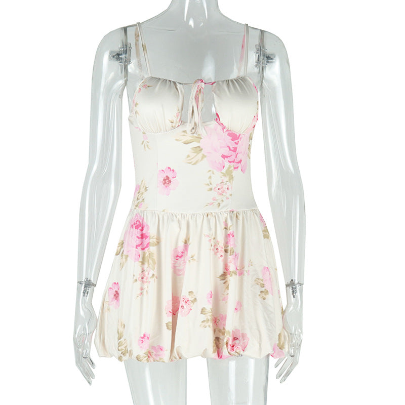 A floral print mini dress with spaghetti straps and a sweetheart neckline is displayed on a mannequin.