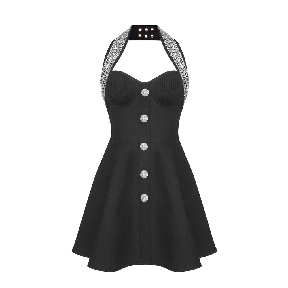 A black halter dress with a jeweled neckline and large button details, displayed on a white background.