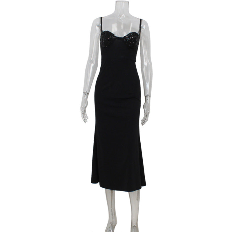 A black sequined midi dress on a mannequin.