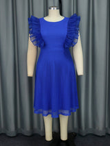A royal blue dress with ruffled sleeves and a mesh overlay on a mannequin