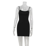 Mannequin displaying a black spaghetti strap slip dress.