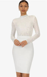 Woman wearing a white long-sleeved mock neck dress with sheer rhinestone-embellished top and a white pencil skirt, posing against a white background.