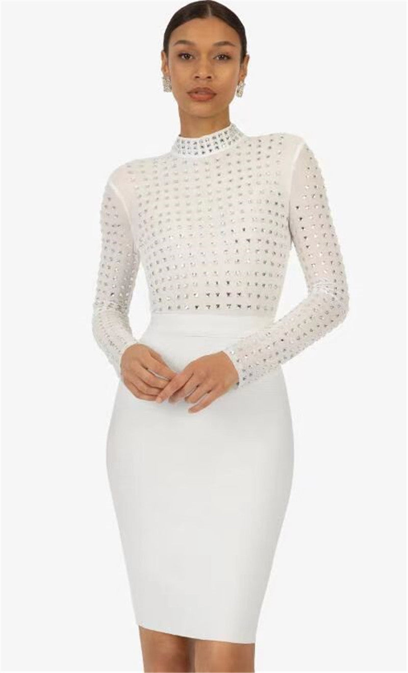 Woman wearing a white long-sleeved mock neck dress with sheer rhinestone-embellished top and a white pencil skirt, posing against a white background.