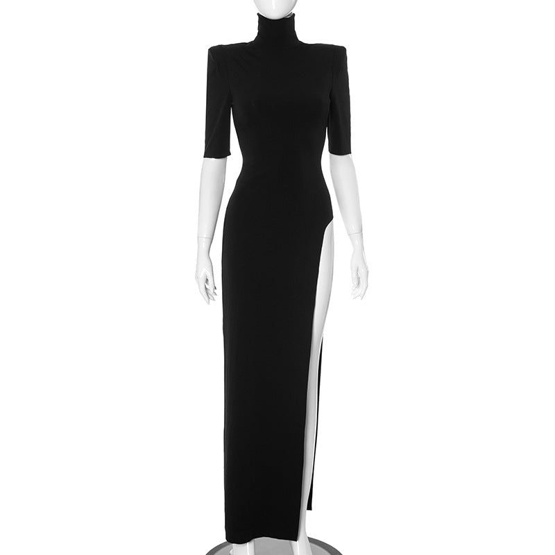 A black dress with a high slit and turtleneck is displayed on a mannequin.