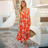 woman wearing an orange and white leaf print tiered midi dress