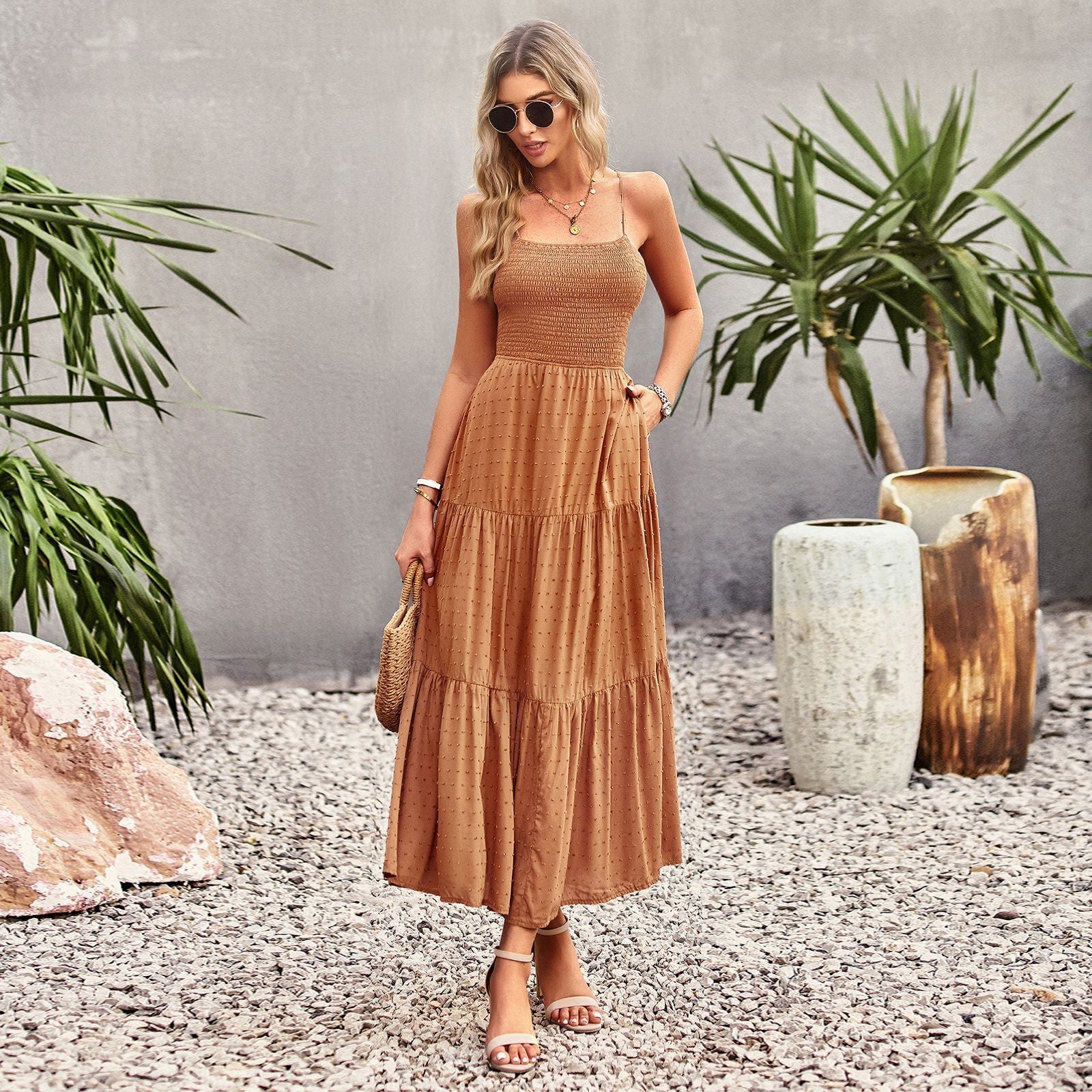 Woman wearing a brown tiered maxi dress with spaghetti straps and smocked bodice