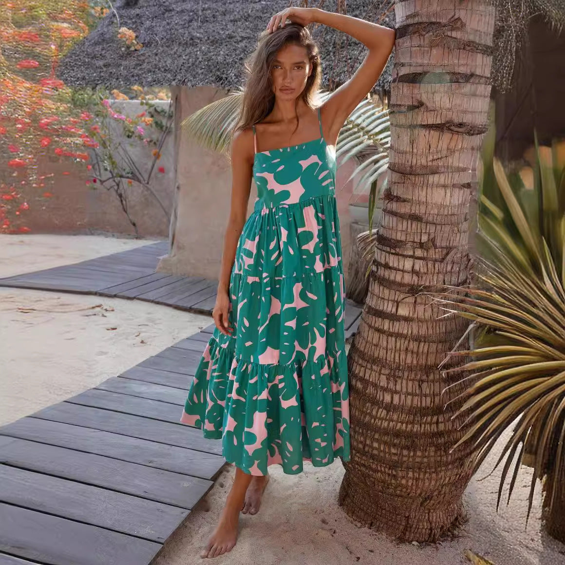 woman wearing a green and pink leaf print tiered midi dress