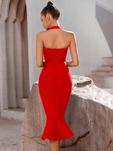 Back view of a woman in a red bandage dress with a halter neck and ruffle hem.