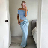 woman in blue off-the-shoulder ruched top and blue draped skirt taking a mirror selfie