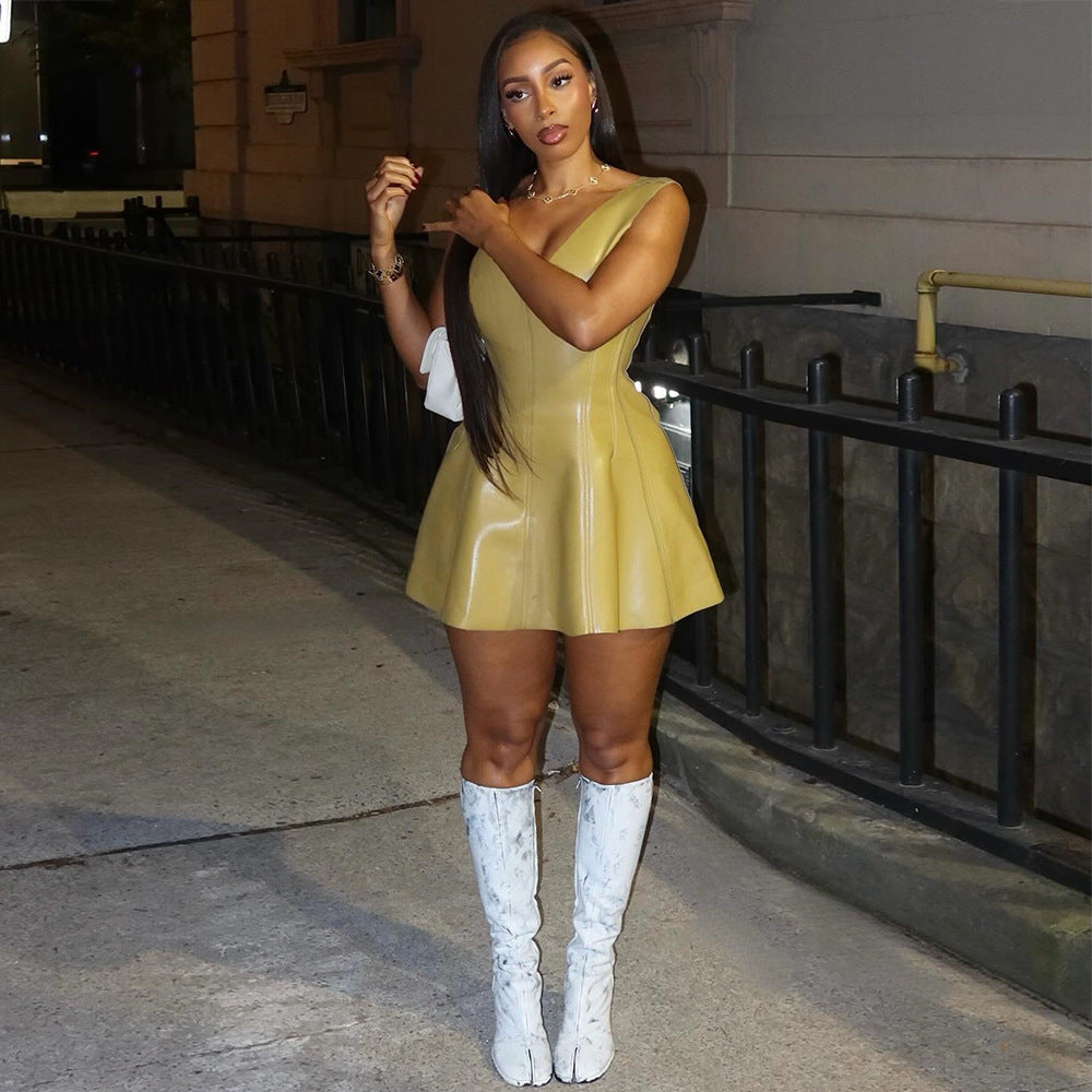 woman in yellow dress and white boots standing outside