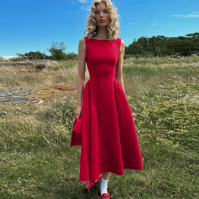 woman in red dress standing in a field
