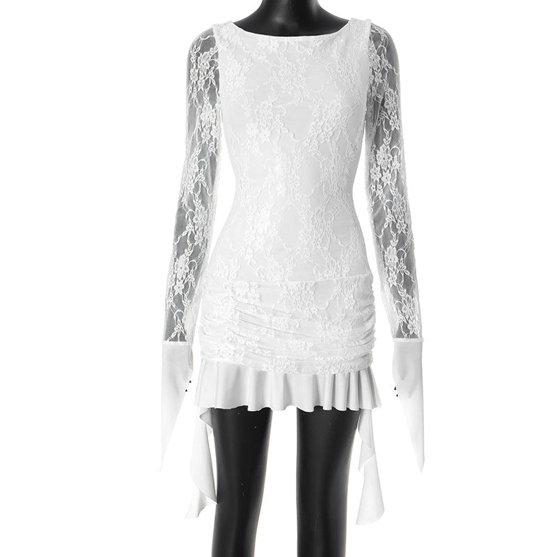 Mannequin displaying a white lace mini dress with long sleeves, ruched detailing, and ruffled trim